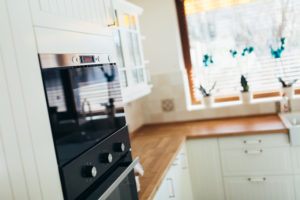 New kitchen appliances in a renovated kitchen, alongside wood countertops and cabinets