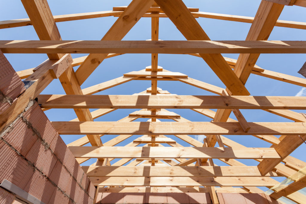 Custom home builders working on a stick-built house