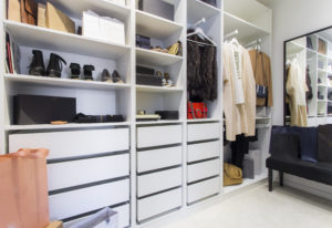 Custom walk-in closet with ample space and compartments for clothes, bags and shoes