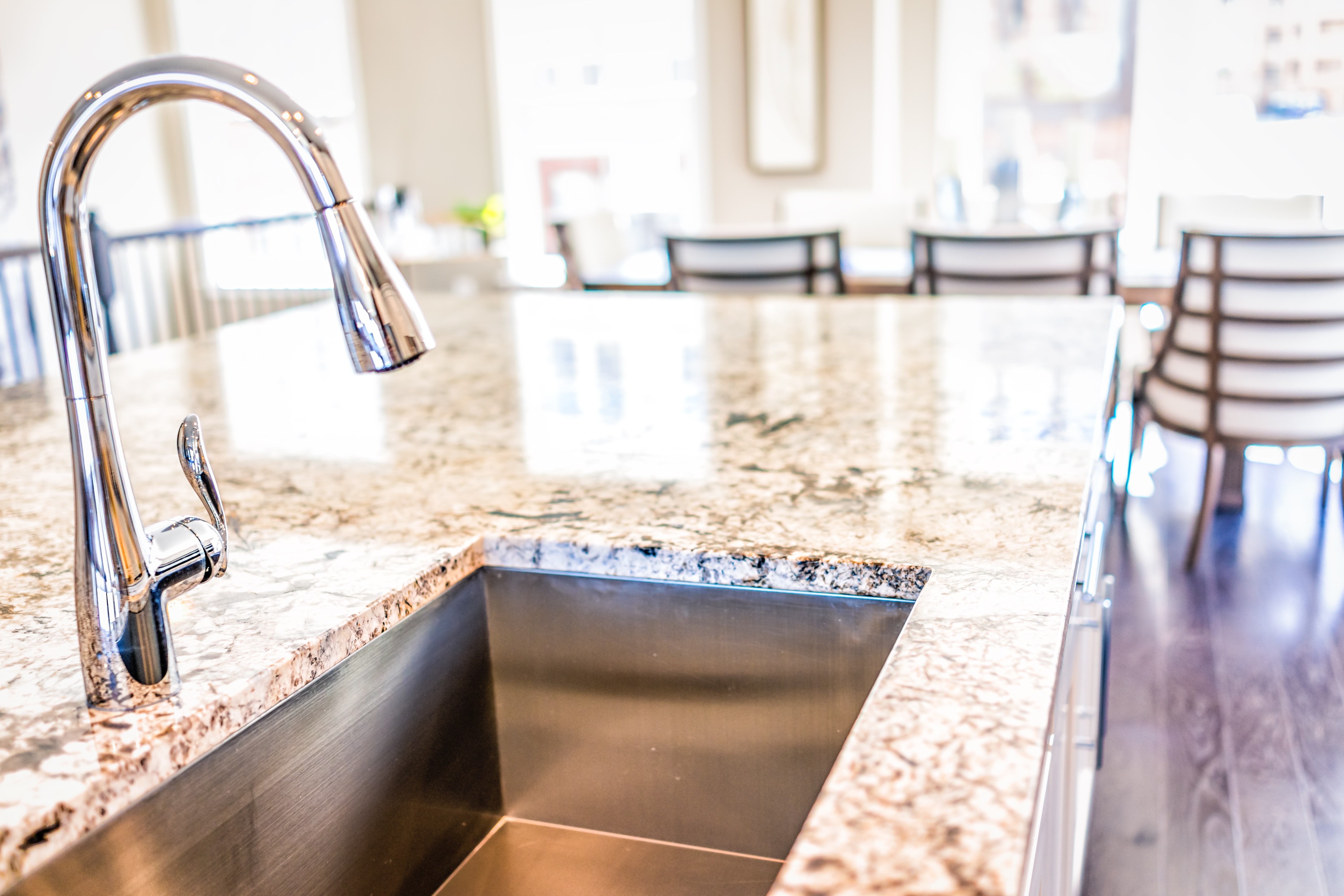 Renovated stainless steel kitchen sink and granite countertops