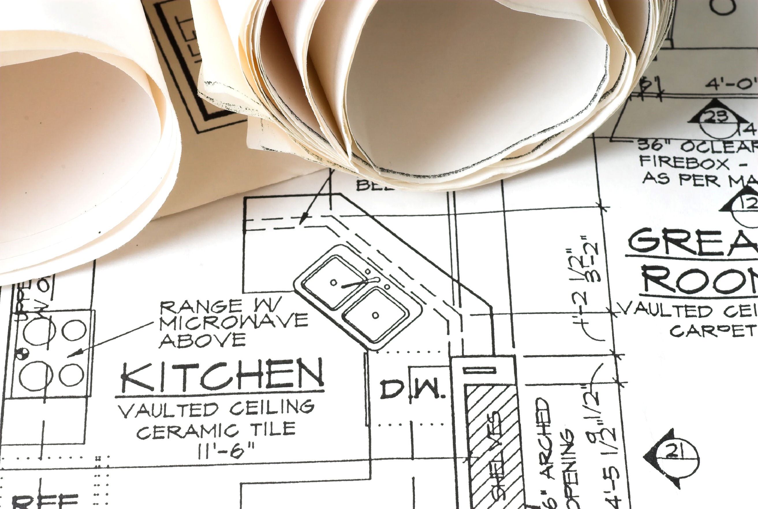 Residential blueprint showing an open kitchen design leading into a vaulted living room